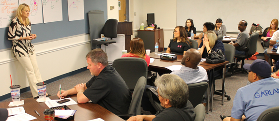 Corporate Services instructor and students in classroom