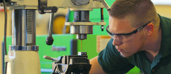 workforce training student working with a machine