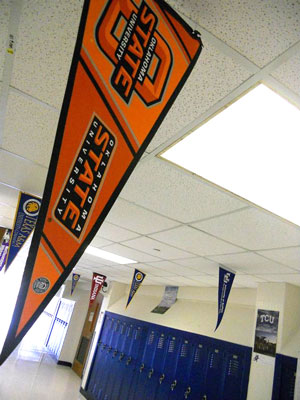 Halls of Samuell ECHS adorned with pennant banners from colleges and Universities
