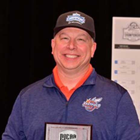 Dallas College Eastfield volleyball's Phil Nickel holding NJCAA coach of the year award