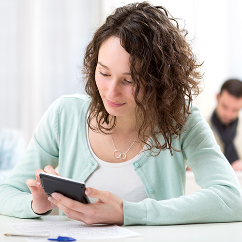 young female working on calculator