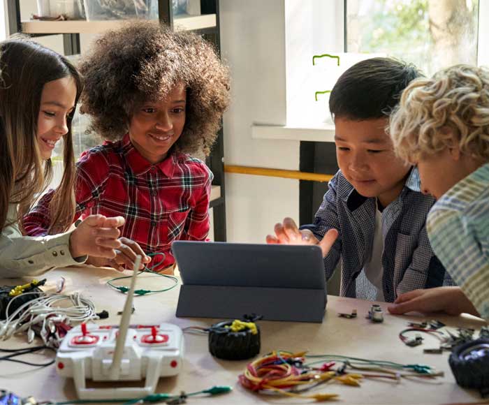 Group of kids having fun learning STEM