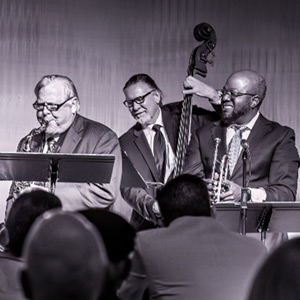 Three men playing jazz on stage