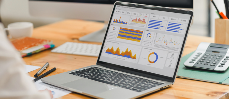 A laptop displaying charts and graphs
