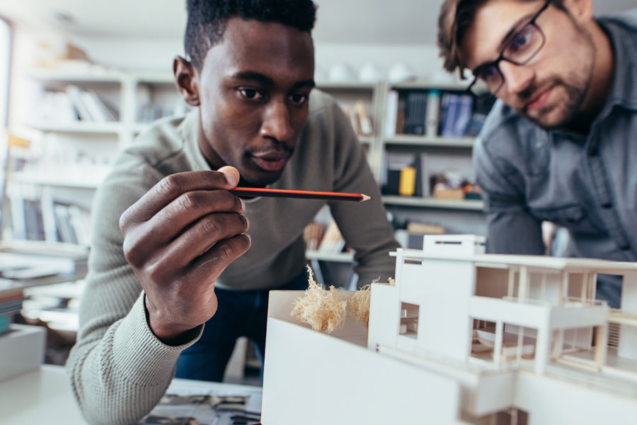 Two Male architects in office discussing construction project