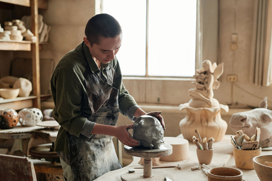 Sculptor making sculptures from clay