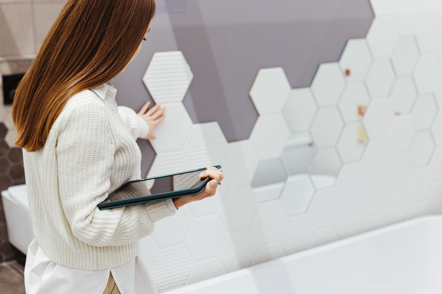 A woman specialist with a tablet checks the quality of work performed and compliance with the design