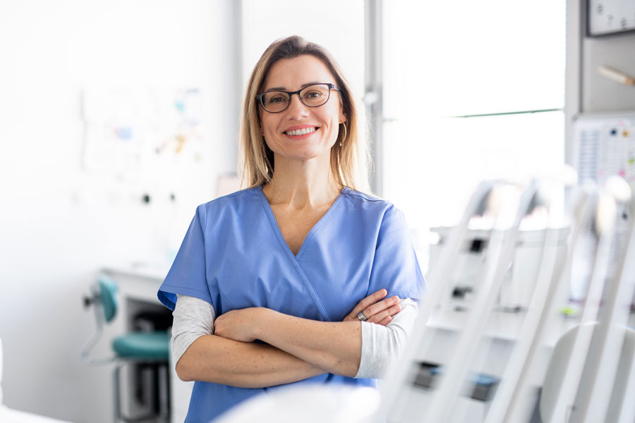 female nursing folding arms and smiling at camera