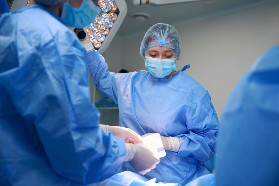 three doctors performing surgery in an operating room