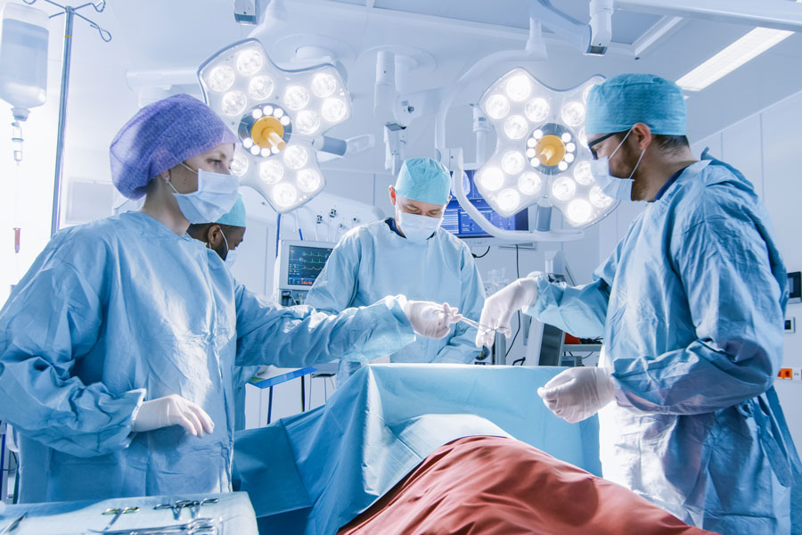 Three female doctors performing surgery in an operating room