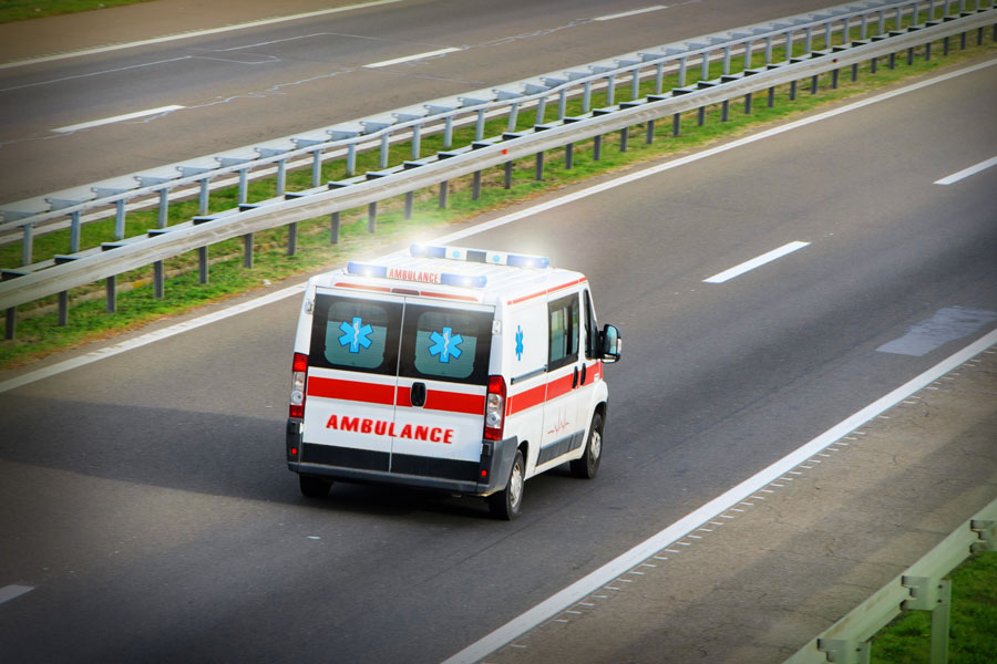 ambulance truck driving down the highway