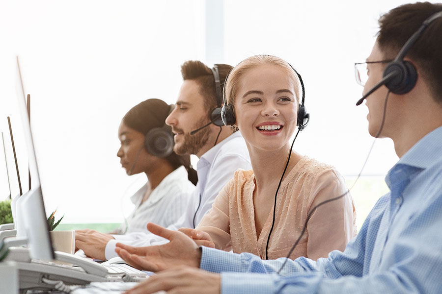 Customer service reps talking with headsets in a call center