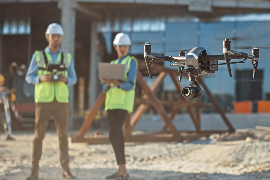 Construction workers in hardhats at a worksite.
