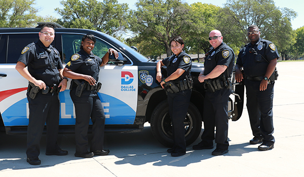 Group of police officers in front of police vehicle