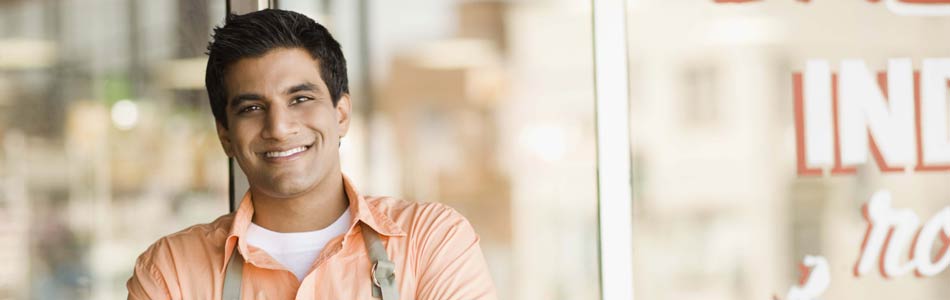 man smiling and crossing arms