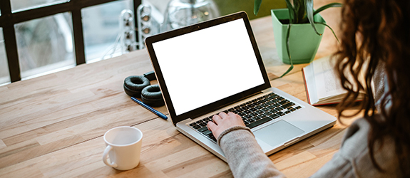 Person working at a desk on a laptop