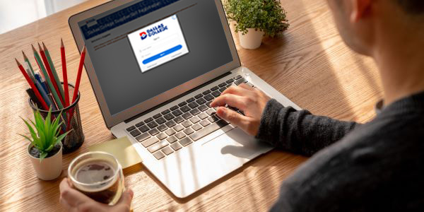 Person using a laptop to register for a Dallas College form