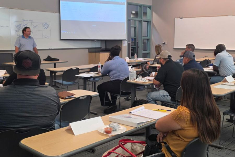 Students sit in a classroom listening to a teacher