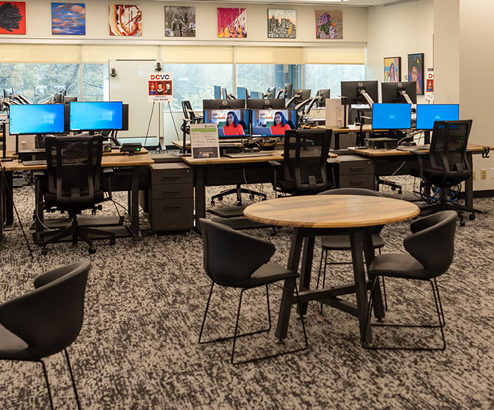 The Venture Club working area with computers and tables