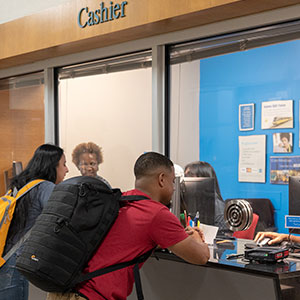 students standing at cashier window