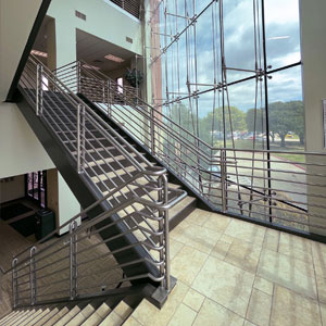 two flights of stairs with a large window in the background
