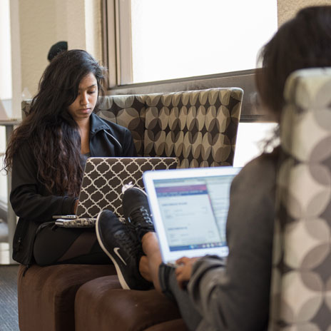 female student on laptop focused on taking classes online