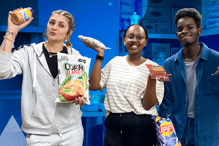 three students hold food items