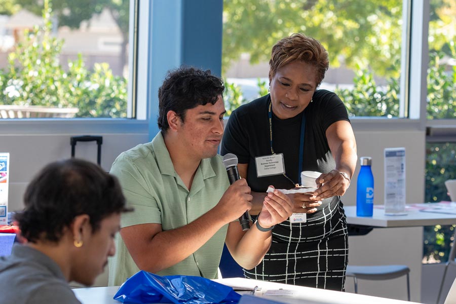 Discussion between two participants at the Business Tech Symposium 2024.