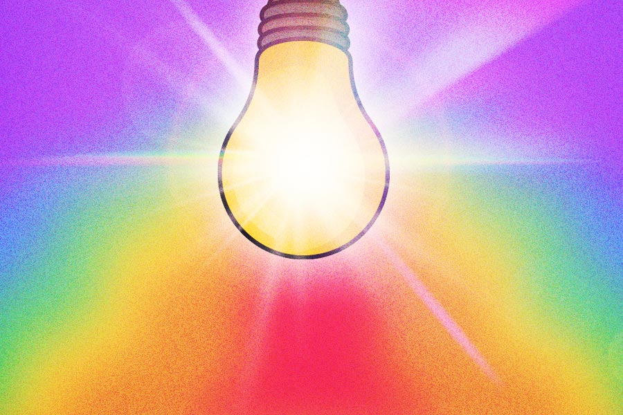 Bright light bulb radiating colorful light