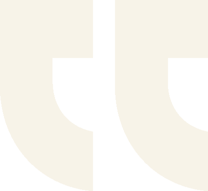 Large light beige quotation marks on a plain background.