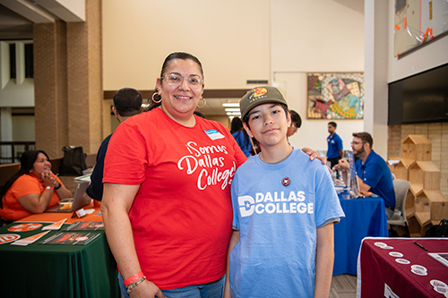 female success coach and male student posing together