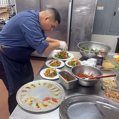 Chef Alex Ortiz setting up food plates