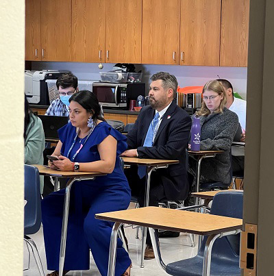 Dr. Justin Lonon sitting in a classroom.