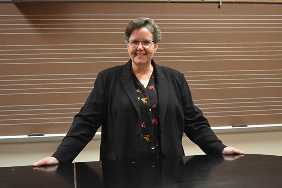 Kathryn Brownlee standing behind a piano.