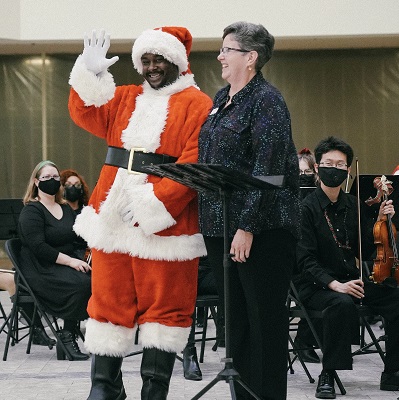 Dr. Kathryn Brownlee standing next to Santa