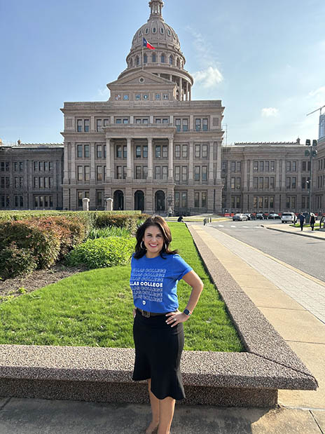 Ana-Maria Ramos standing in front of the Texas capitol building wearing a Dallas College t-shirt.