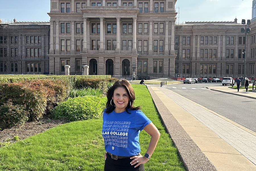 Ana-Maria Ramos standing in front of the Texas capitol building wearing a Dallas College t-shirt.