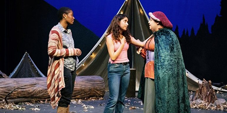 Three women having discussion on stage.