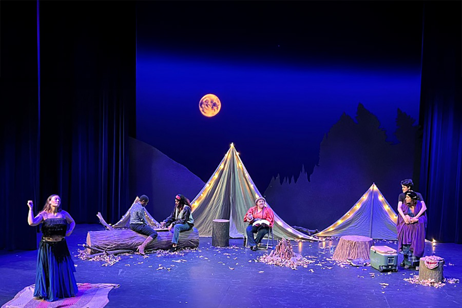 Stage scene with six actors.