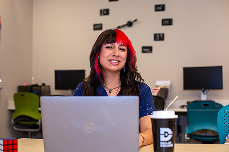 Maris Rodriguez working on laptop