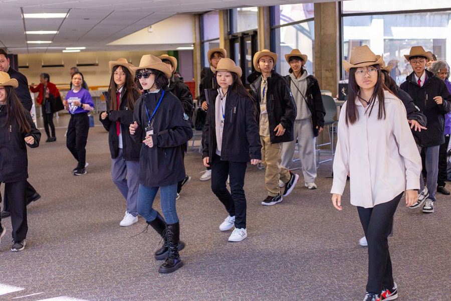 Group of Taiwanese visitors line dancing