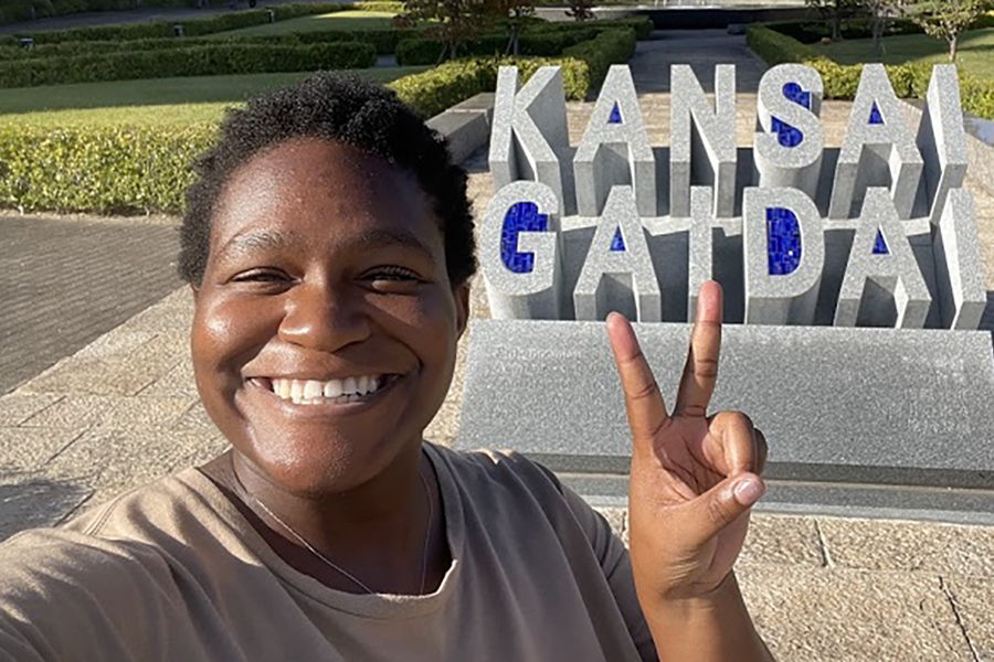 Zoe Phillips giving peace sign in front of Kansai