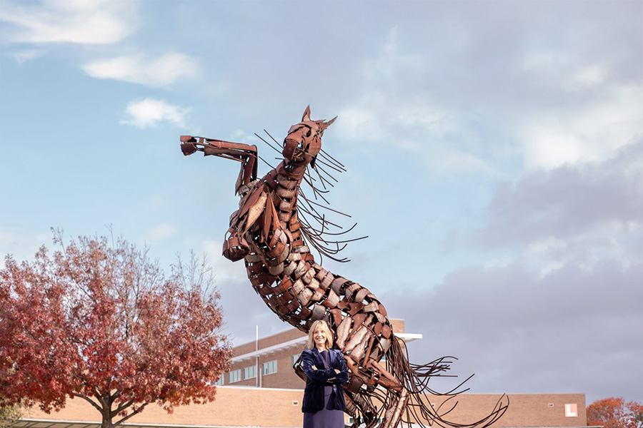 Christa Slejko with horse sculpture.