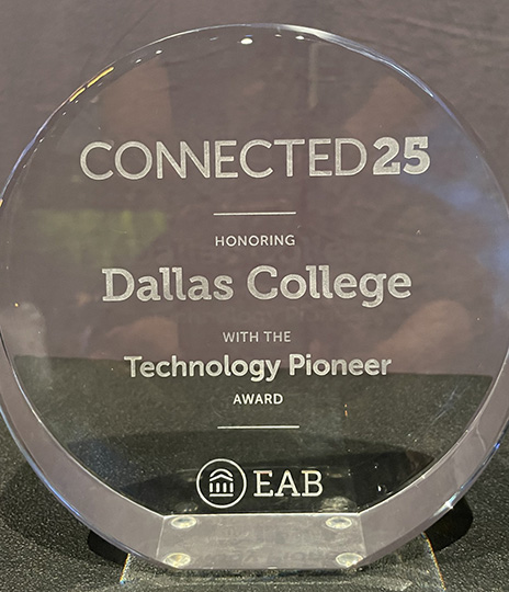 Glass award that reads: Connected 25 Honoring Dallas College with the Technology Pioneer Award EAB
