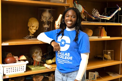 Student poses with anatomy models
