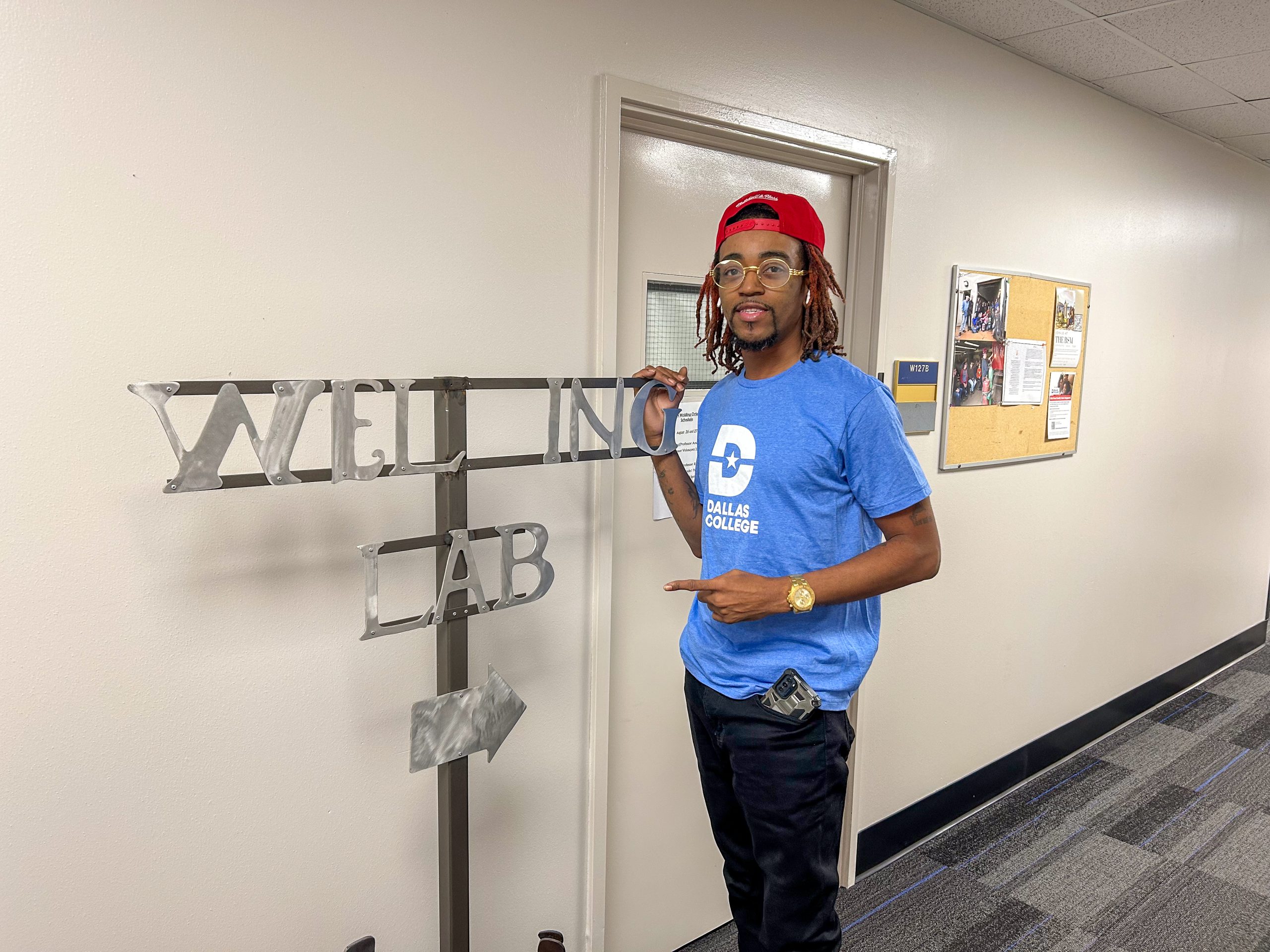 LeShawn Lee standing in front of Welding Lab sign