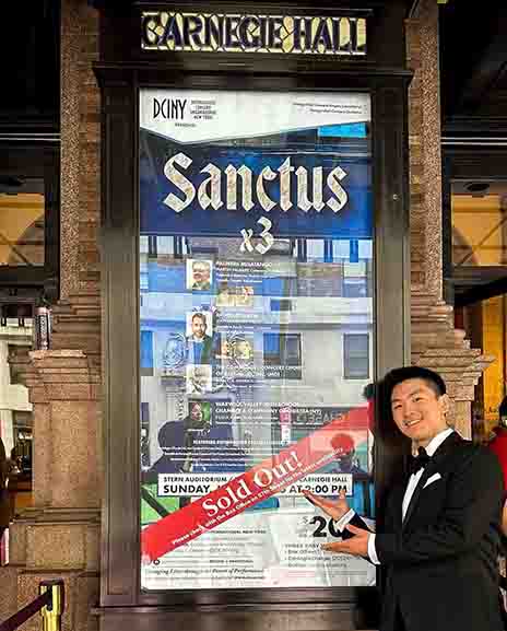 Zelong Feng posing with Carnegie Hall billboard.
