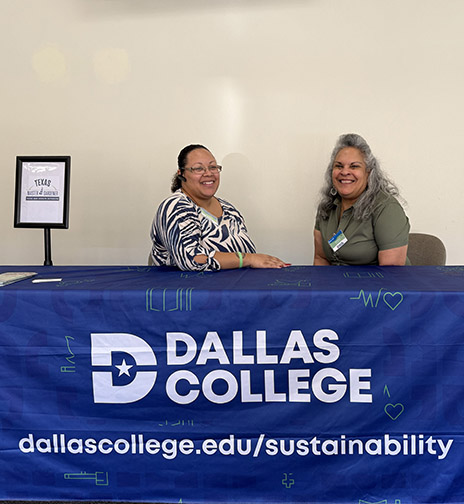 Shanelle Tennyson and Sonia Ford sitting at sustainability table.