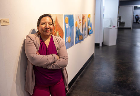 Tina Medina standing in art gallery