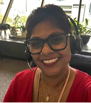 Vasana Moran-Hernandez at work with headset on.